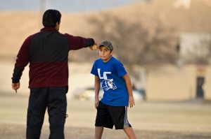 PUT ME IN COACH: A Las Cruces little leaguer takes instruction at the Intramural Fields on New Mexico State University's main campus, Feb. 17. 