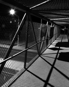 A caged walkway over main road.