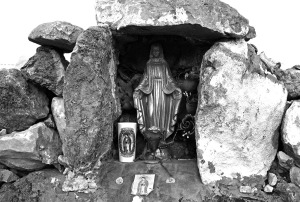 There is a small stone sanctuary made for the saint that remains throughout the year for people to pray to. Often you will find notes and items left at the altar. Sometimes there are uniform name patches, sometimes pet collars, and often candles.