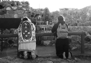 Many wear the emblem of Guadalupe on their clothing or carry flags, and homemade representations. The young girl on the right was one who climbed the mountain barefoot, before kneeling to pray she walked quite slowly and you could tell her feet were in pain.