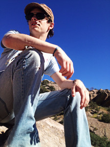 NMSU Student Ryan Elberg resting on a rock during a hike in Dripping Springs.