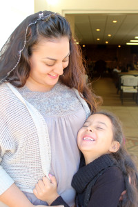 Cynthia Herrera looking at her daughter and them both smiling.
