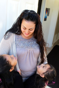 Cynthia Herrera staring at her daughter and having them both smile up at her.