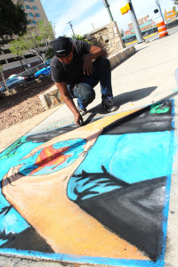 Chalk the block event. Juan Cruz drawing with chalk on the sidewalk.