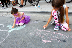Chalk the block event. Taking feature pictures of little girls drawing on the street.