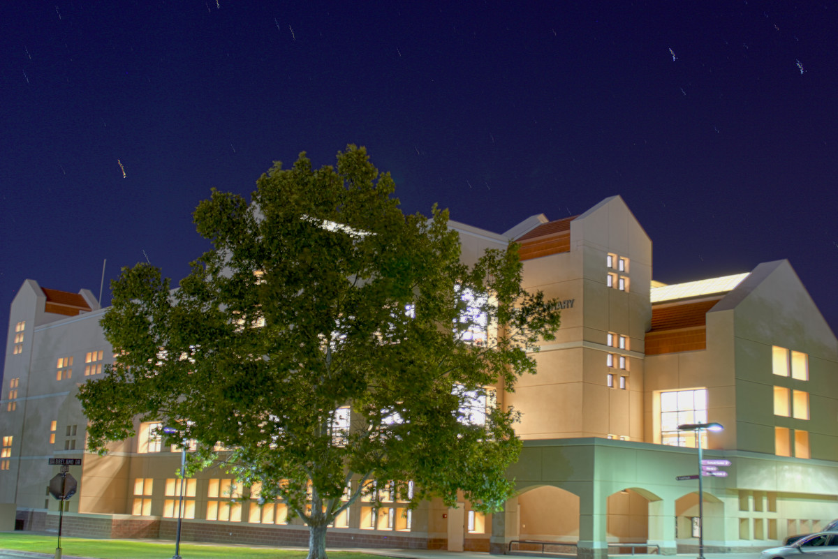 Zuhl Library is illuminated at night by the bright lights inside.
