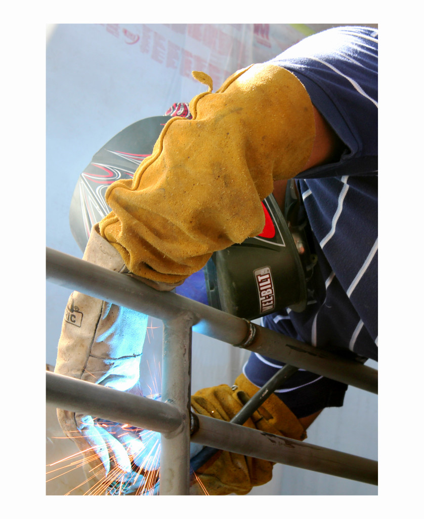 One of the Wooten Construction workers welds the railing together in Corbett Center during the remodeling process.