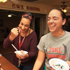 Chi Omega members Aliza Voit (left), 18, and Ashley Allen (right), 21, share a laugh and serve themselves some ice cream before planning out their classes for the spring semester at NMSU Wednesday, Nov. 11, 2015.
