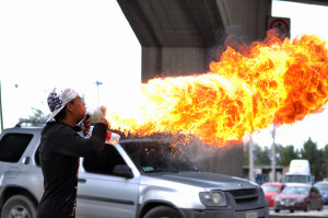 Alfredo Humberto Velásquez firebreathing at street intersection while the light is on red in Ciudad Juárez.