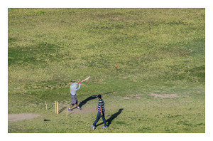 El Pasoans play cricket in a high school field. Shot with telephoto lens from atop Tom Lea Park on the Franklin Mountains. 