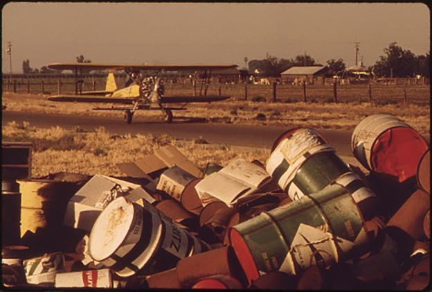 In 1972, the U.S. Environmental Protection Agency hired Gene Daniels and hundreds of fellow photographers for the Documerica project. From 1971-1978, these photographers assisted the agency’s aim to document changes in the American environment. 
This photo is particularly daunting from my perspective gained from working with pesticide regulation with the aim of consumer and environmental protection. Another image from his collection, shows a massive hillside egregiously marked with black oil waste. (Daniels, 1972). Both of these images serve as a frightening visual before-and-after of improper chemical and waste disposal. 
